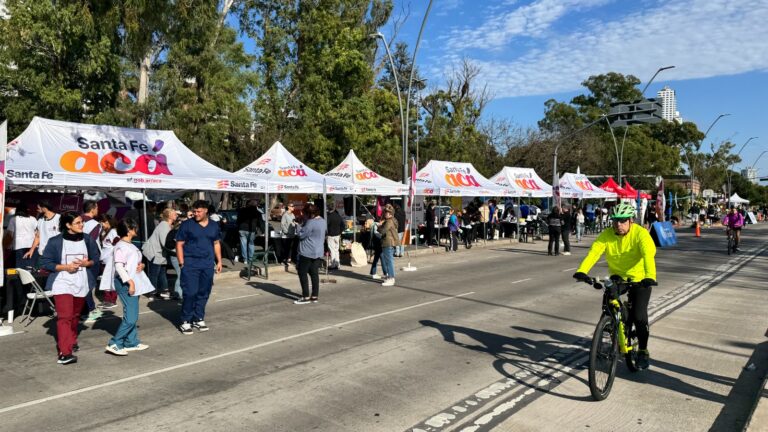 Ciclista circulando por la Calle Recreativa de Rosario junto a un operativo del Gobierno de Santa Fe.